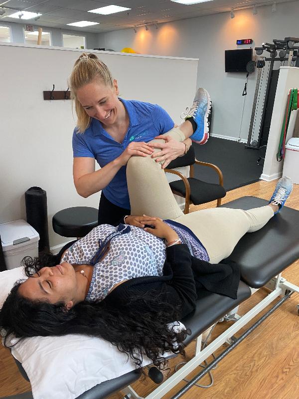 Physical therapist performing a physical assessment on patient