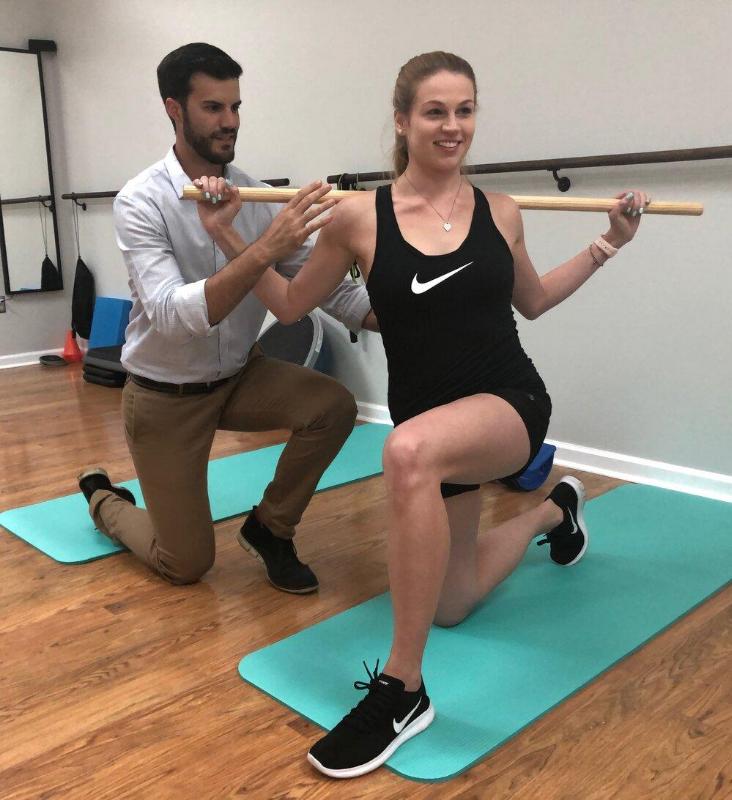 Physical therapist assisting patient's exercise